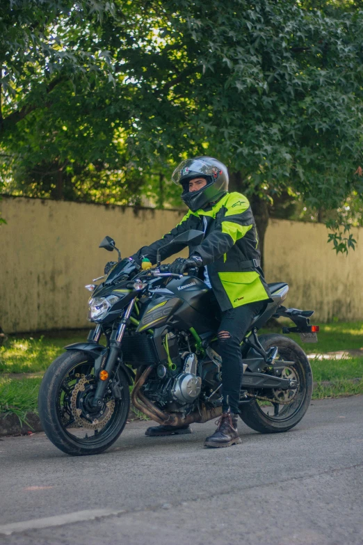 a person on a motorcycle with trees behind them