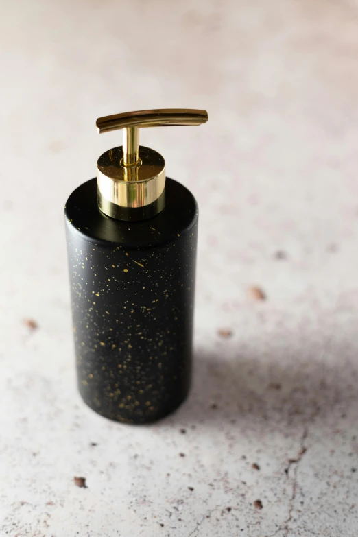 black and gold soap dispenser on a counter