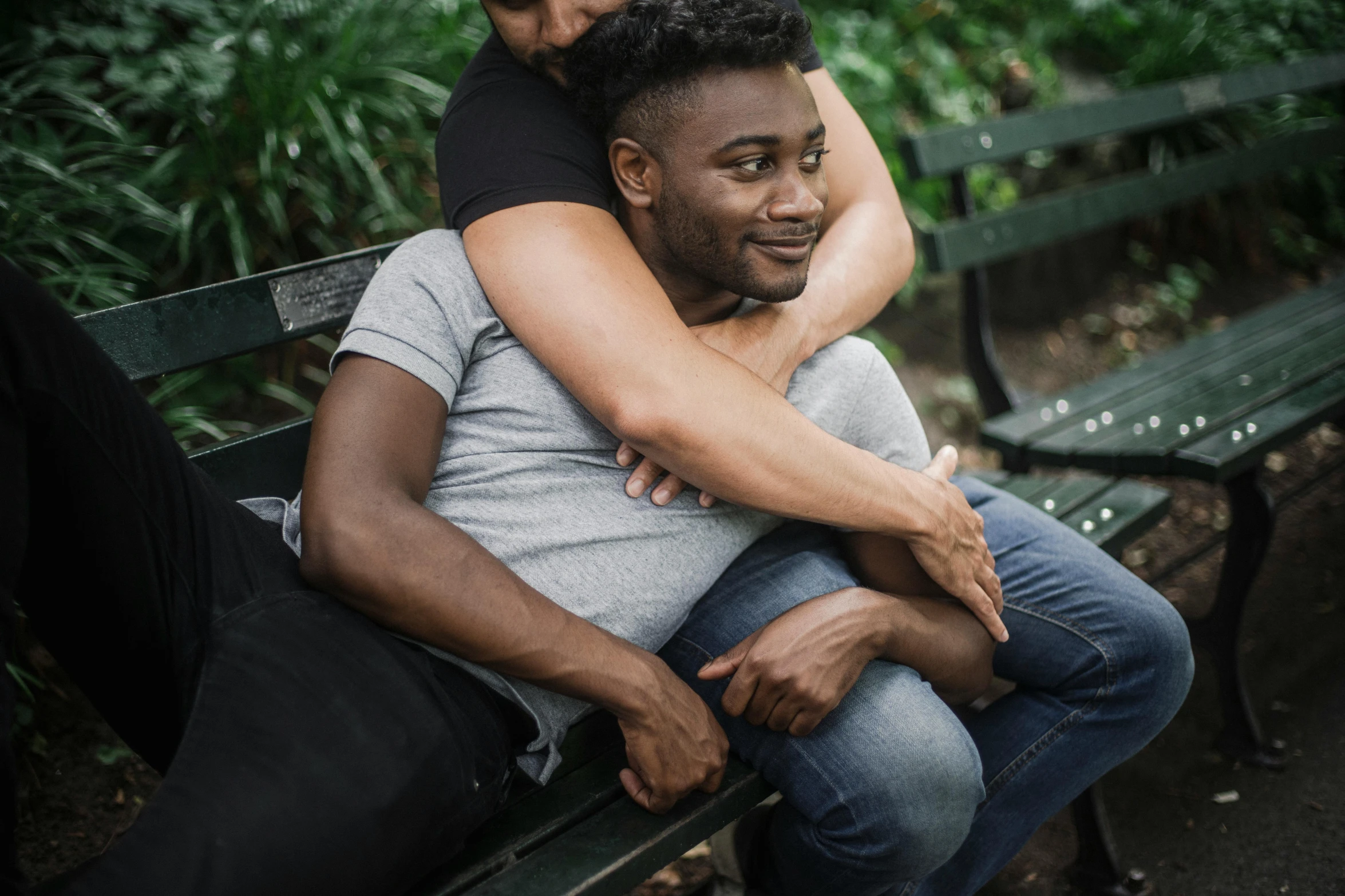 a couple hugs on the bench at the park