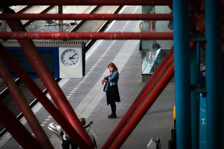 the woman stands alone while looking into the distance