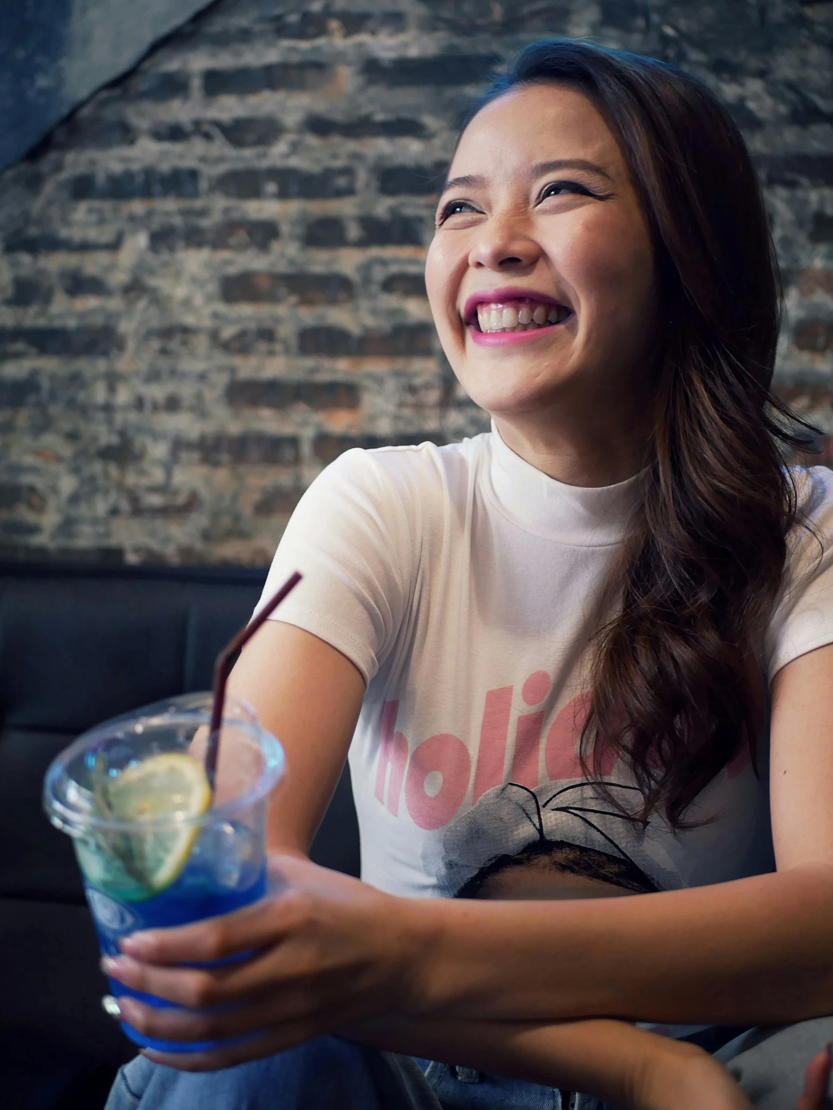 smiling woman holding a drink in her hands