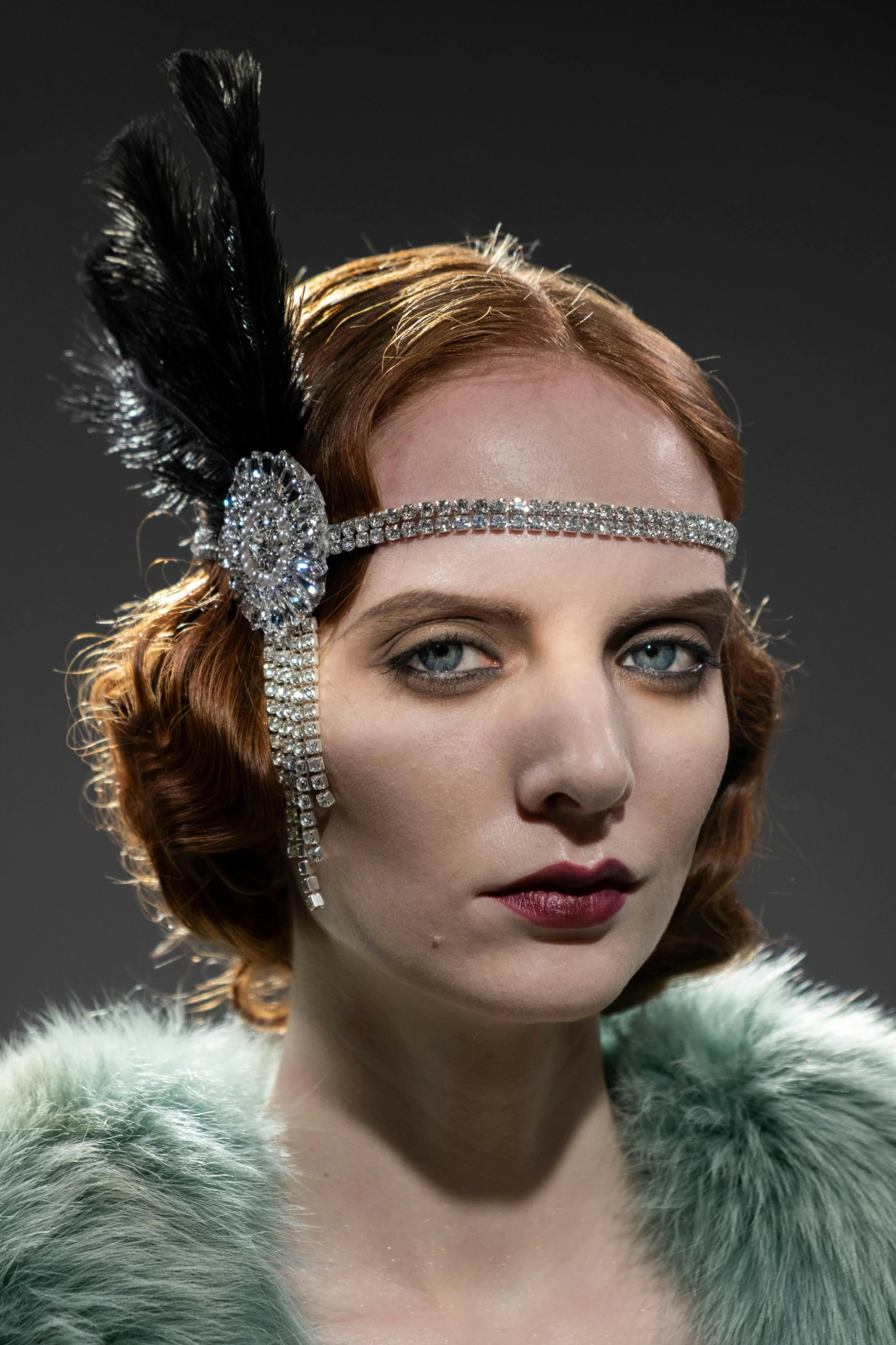 woman wearing headpiece with feathers and jewelled trim