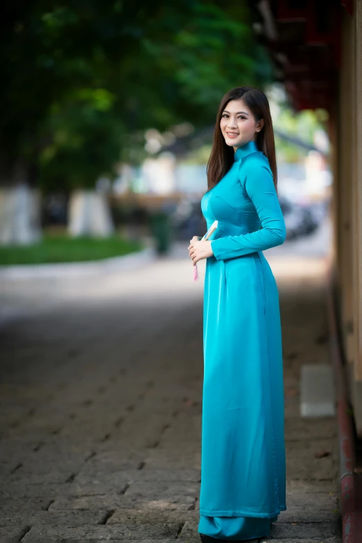 an oriental woman poses with her hands on her stomach