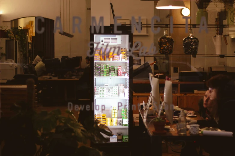 the refrigerator is reflecting its display in the glass