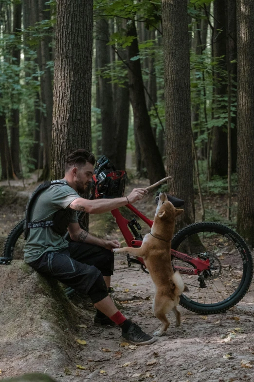 a man with a bicycle and a small dog outside