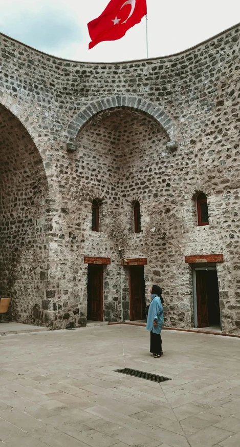 a person standing in front of a wall with two archways