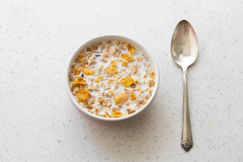 a bowl with cereal and some other things next to it