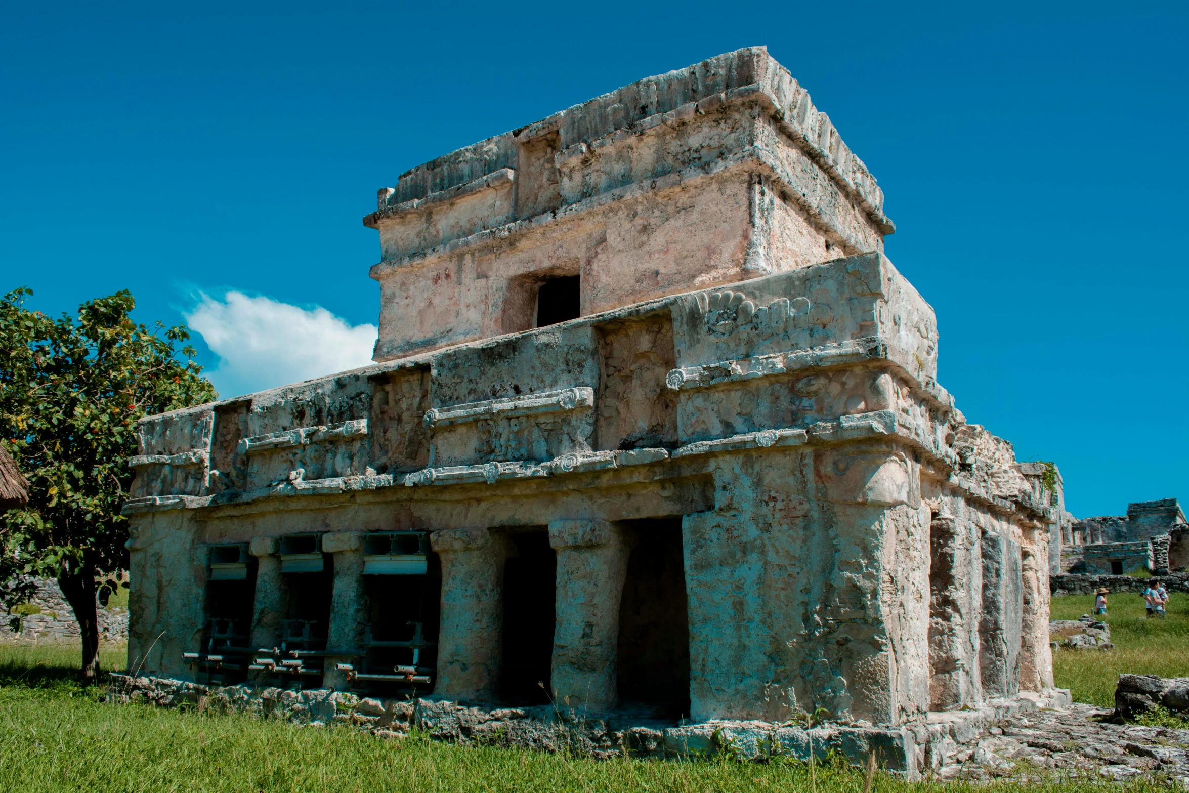 a stone building in the middle of grass