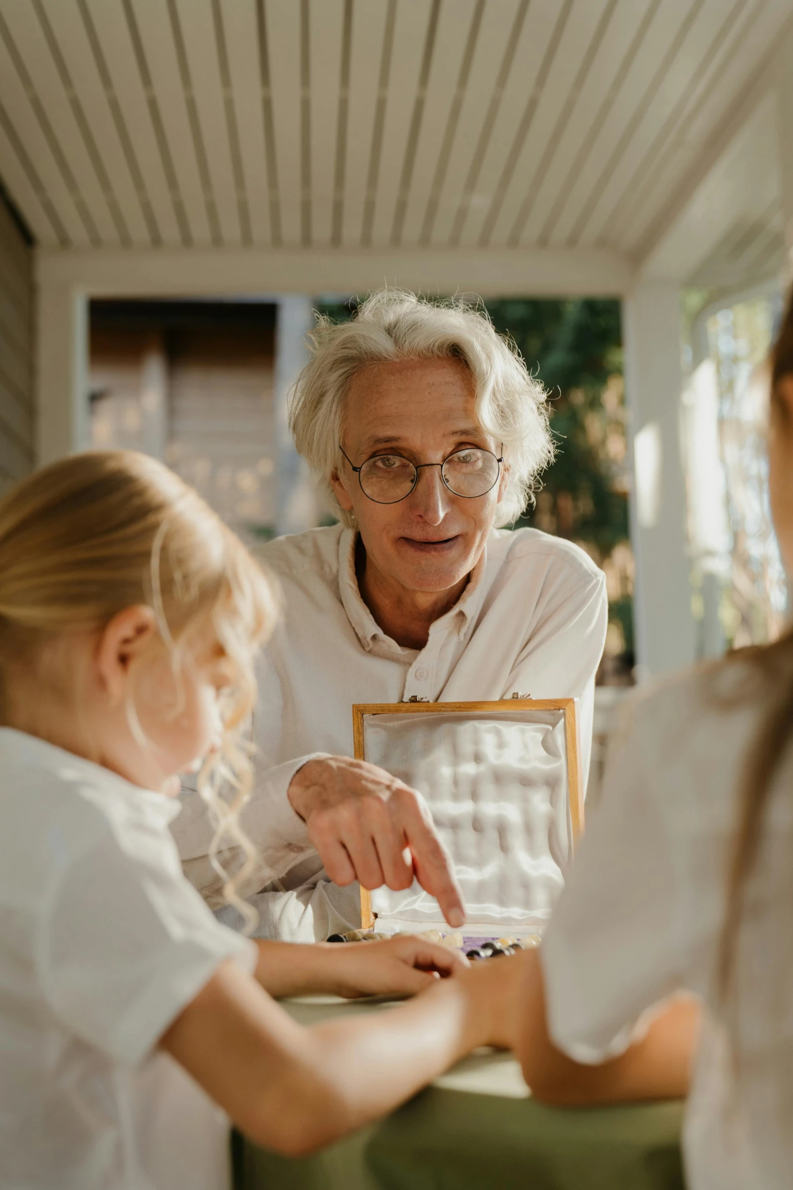 a woman holding a box of chocolates with two s