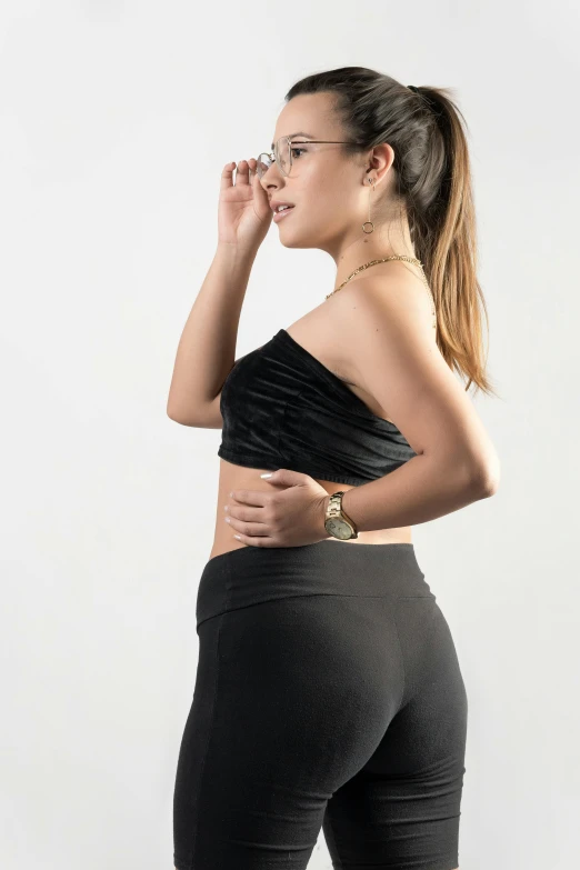 woman in black top and leggings smoking a cigarette