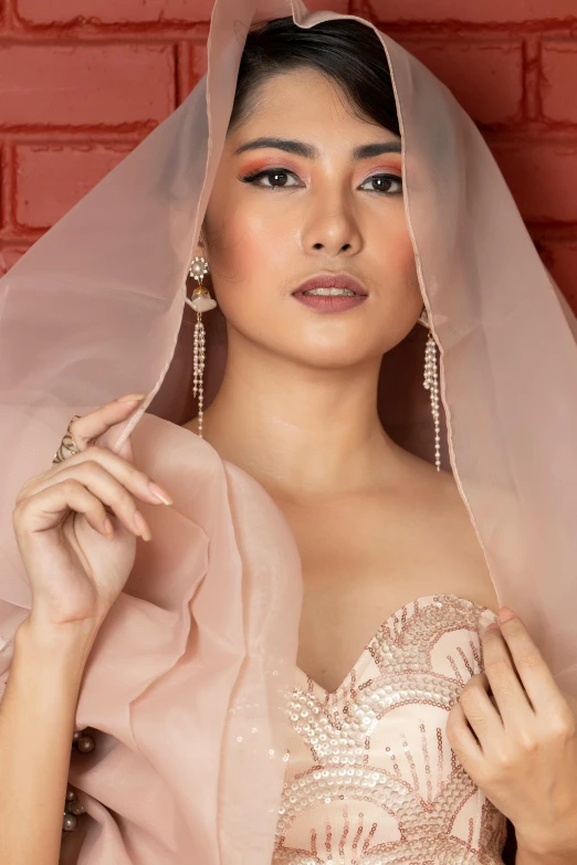 a woman wearing a veil and dress is posing