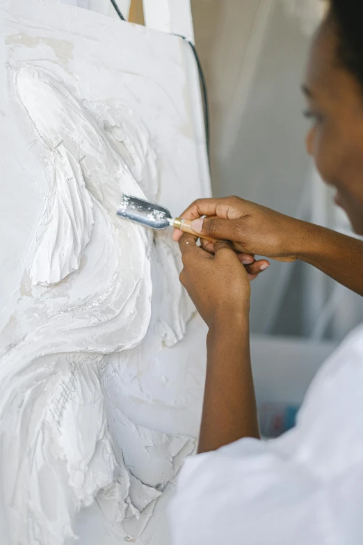 the woman is painting an art piece in progress