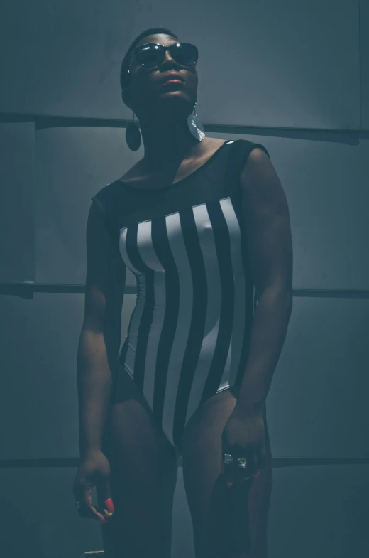 an african american woman is wearing a black and white  bodysuit