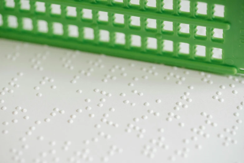 a close up of a green and white plastic tray