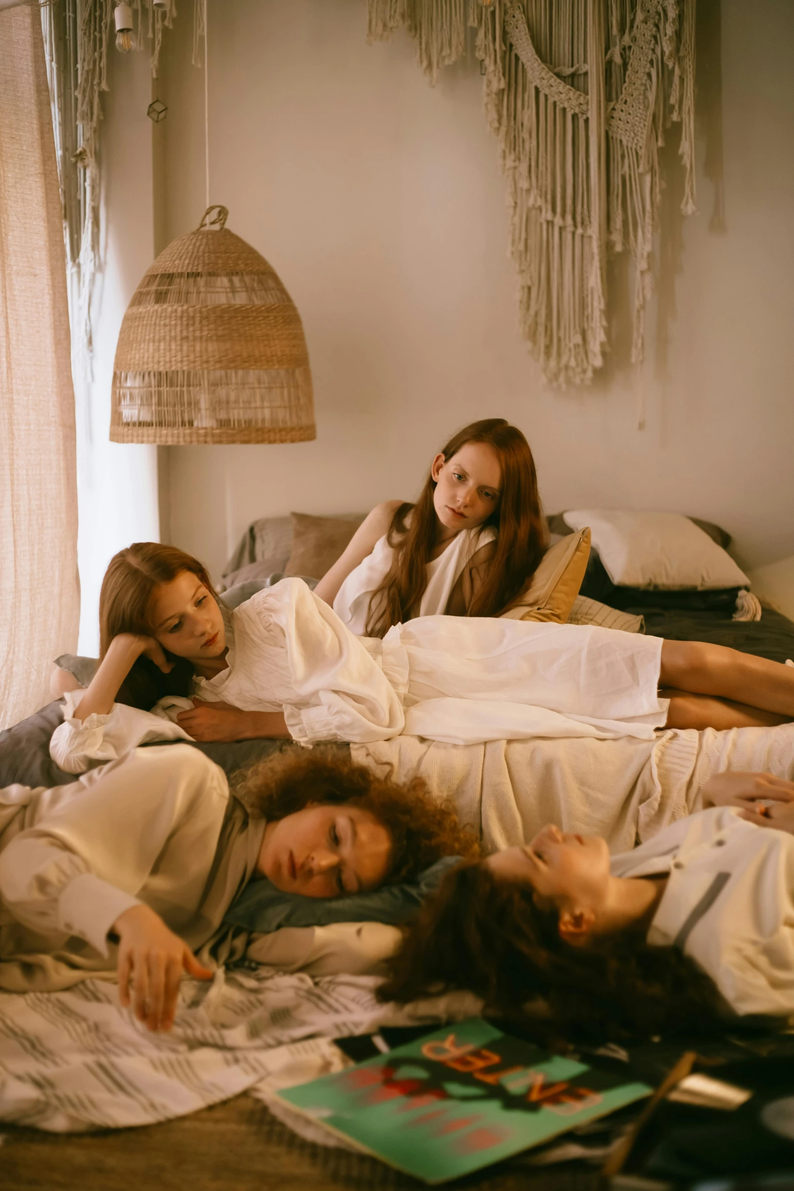 a group of girls are laying on a bed