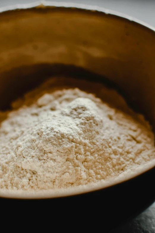 a black bowl has some white powder in it