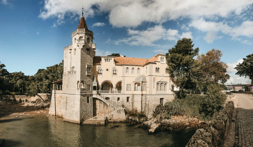 an old church next to a body of water