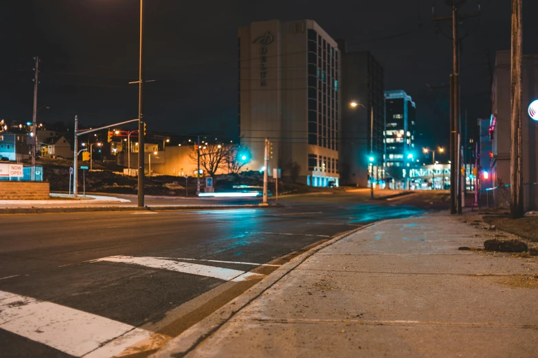 a empty street corner with street lights and traffic signs