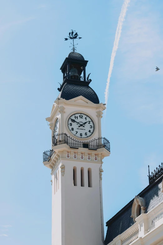 a steeple with a clock against a blue sky