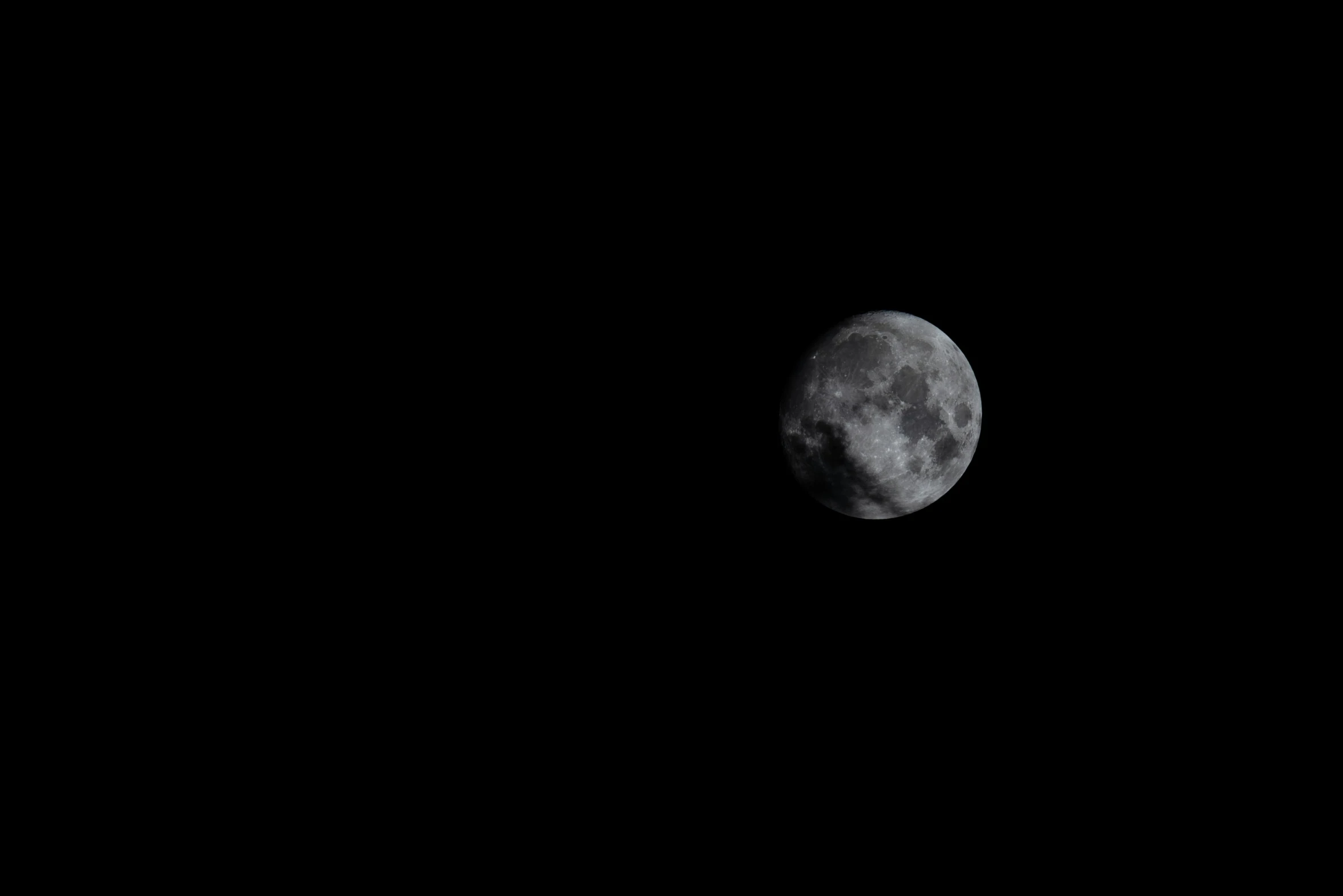 the moon seen from the earth on an empty black night sky