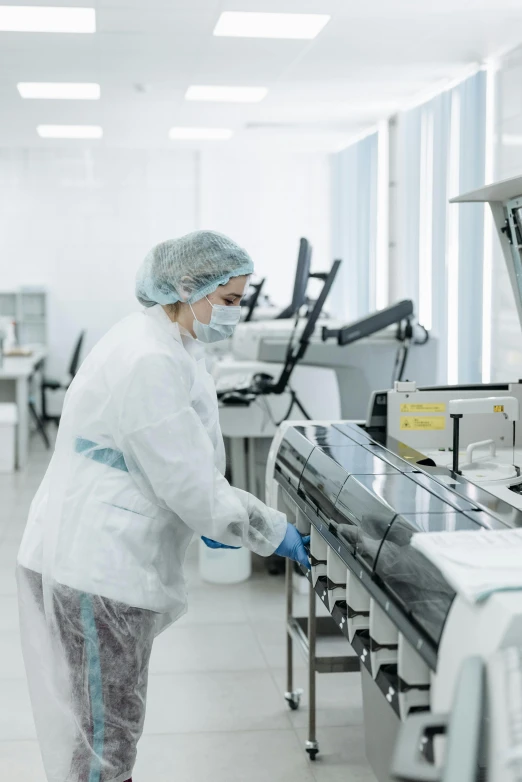 a worker in a white jacket is working inside a factory