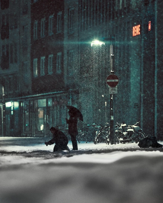 two people walk through the snow at night on the street