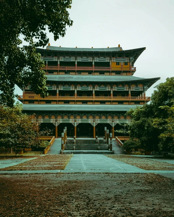 an asian building with a long courtyard in front