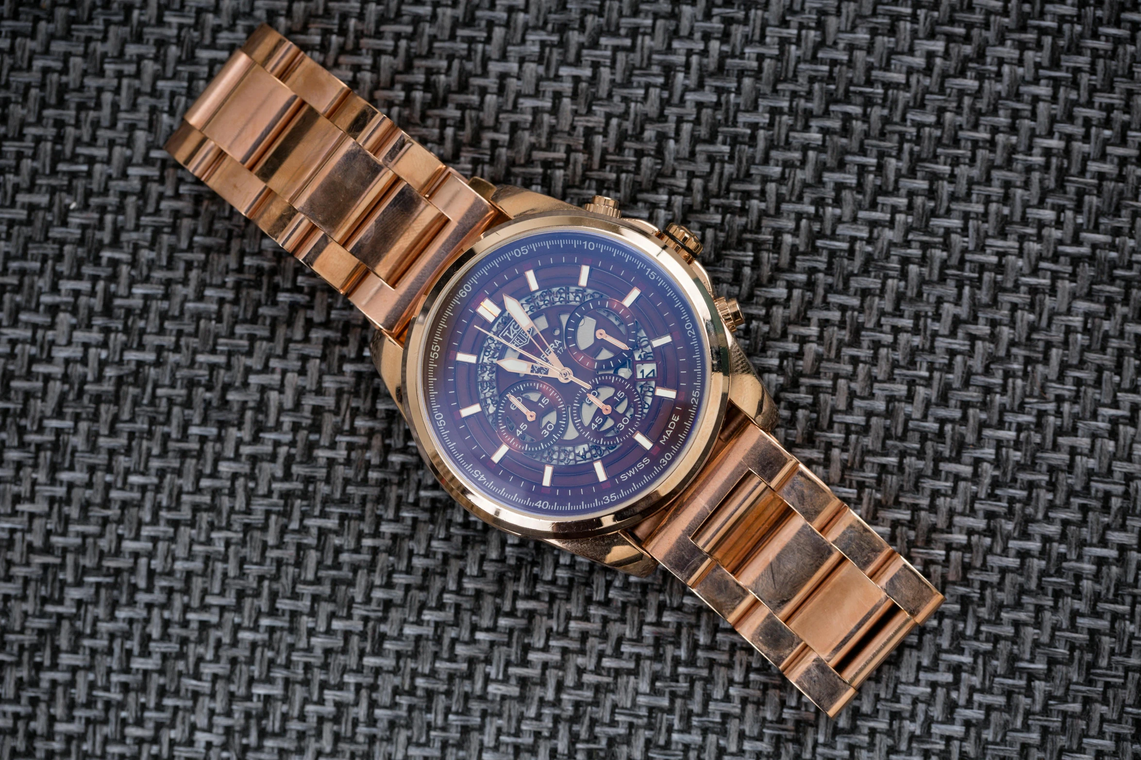 an elevated view of a mens watch that is on a surface