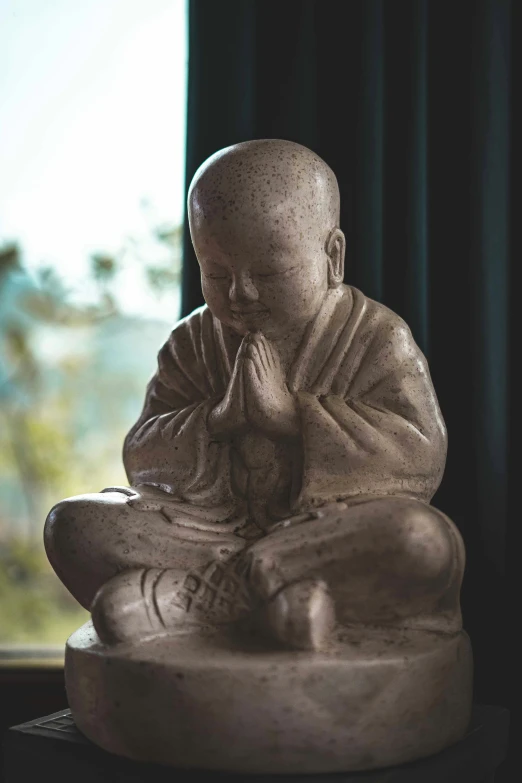 the statue is seated while praying