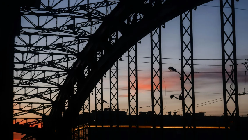 a bridge with a red sky in the background