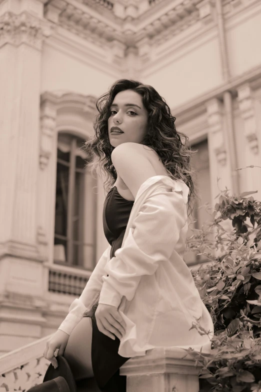 a woman sitting on a chair in front of a building