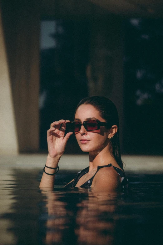 a woman wearing sunglasses in the water