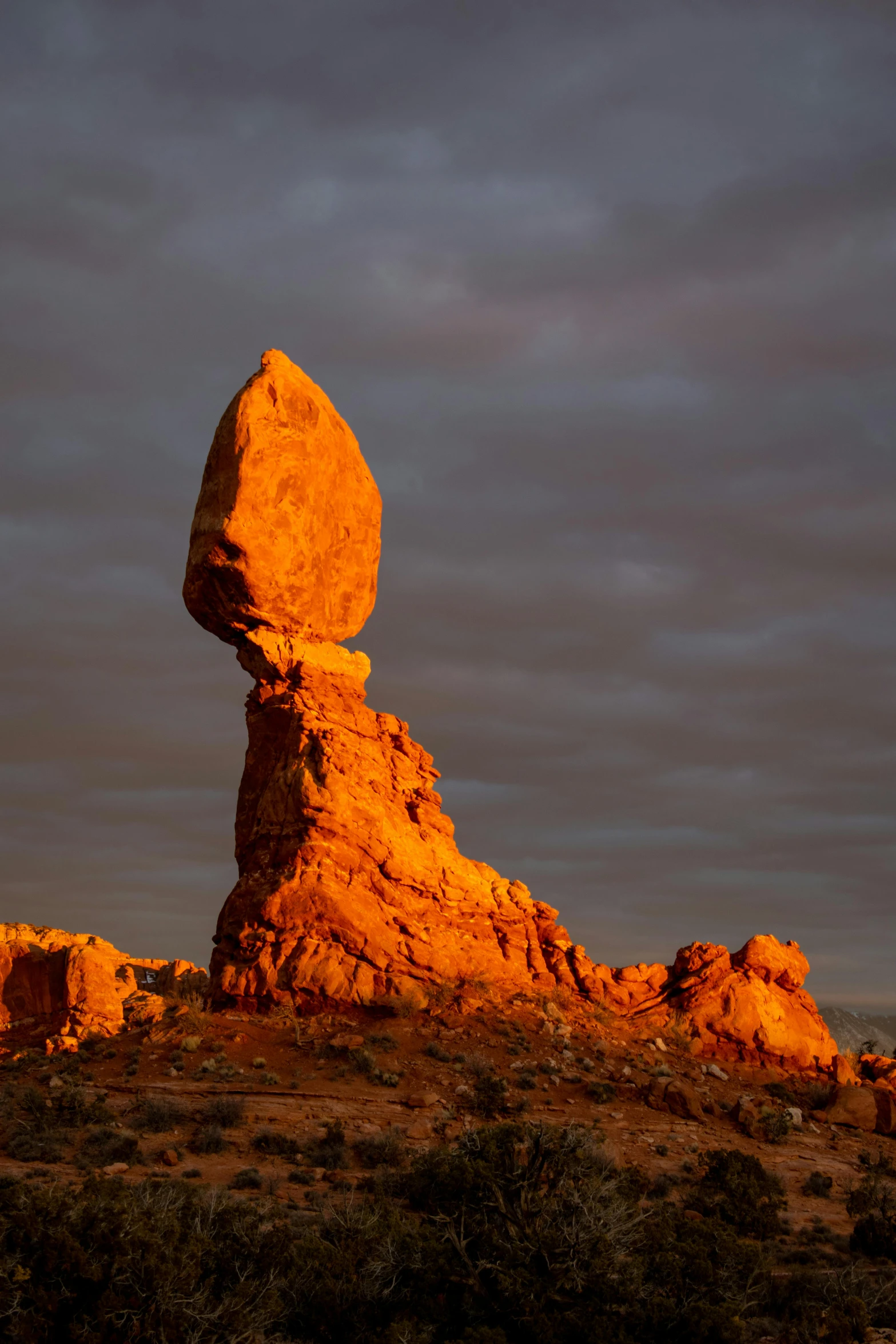 large rock formation on the horizon against an overcast sky