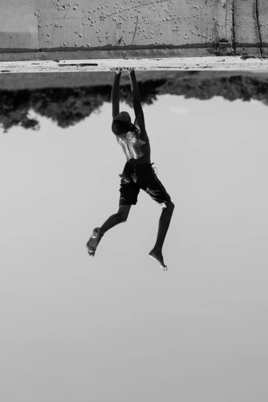 a man jumping in the water with a surfboard