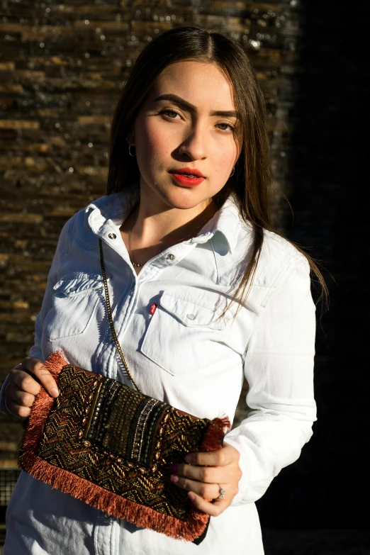 a woman holding a purse with one hand