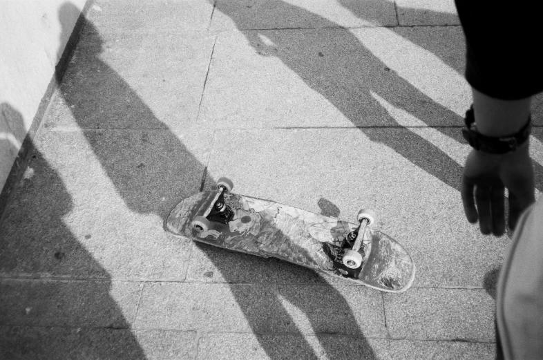 the skateboard has been left abandoned on the sidewalk