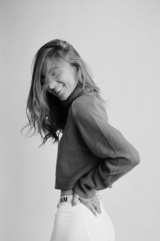 black and white pograph of a young woman wearing a sweater