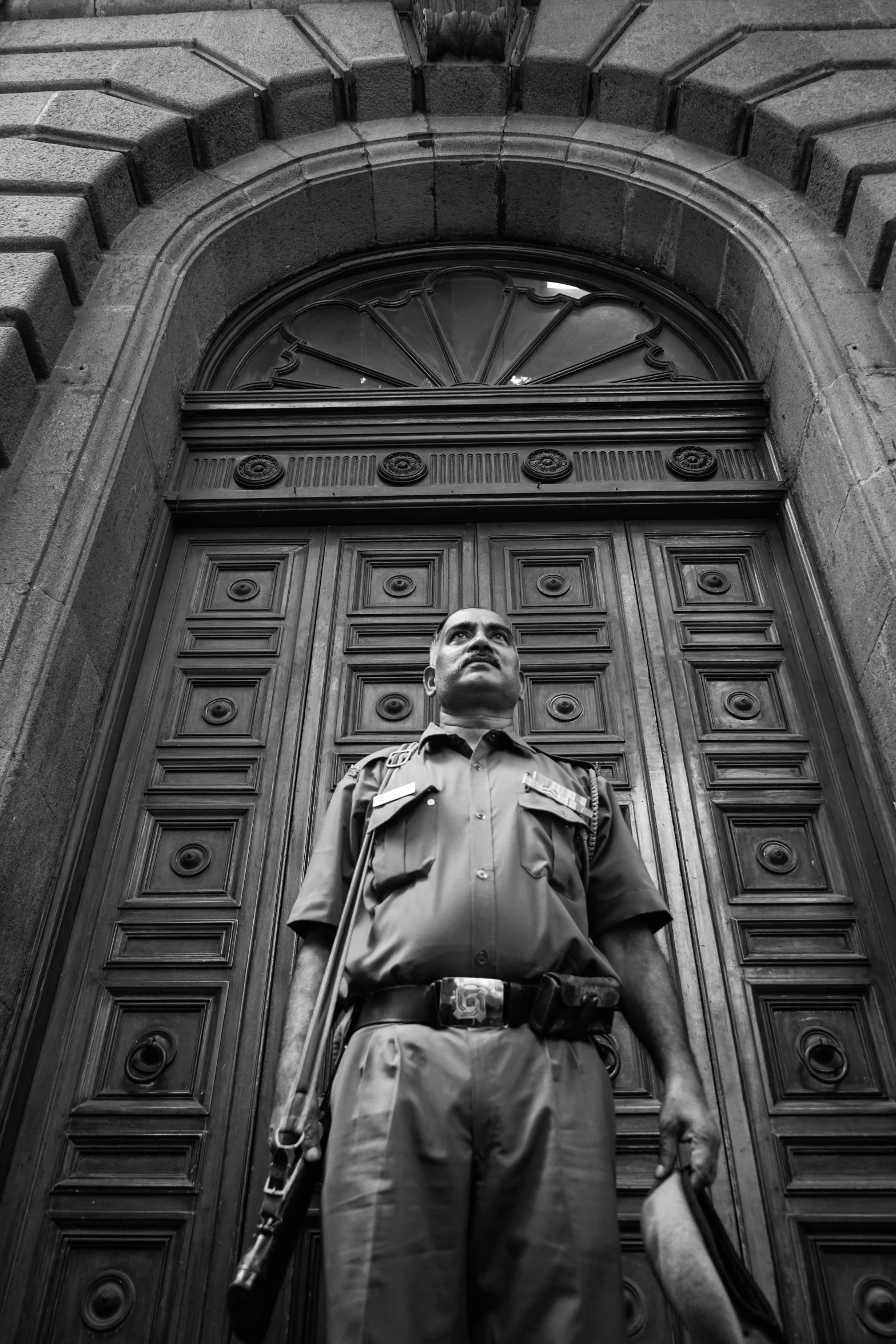 a statue of an officer in uniform stands in front of a doorway