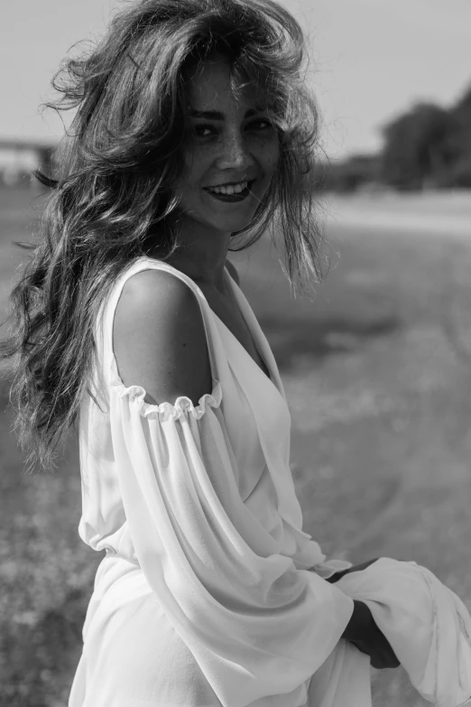 black and white po of a woman in an off - shoulder dress