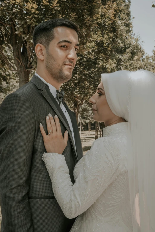 the newly married couple stand in the sun