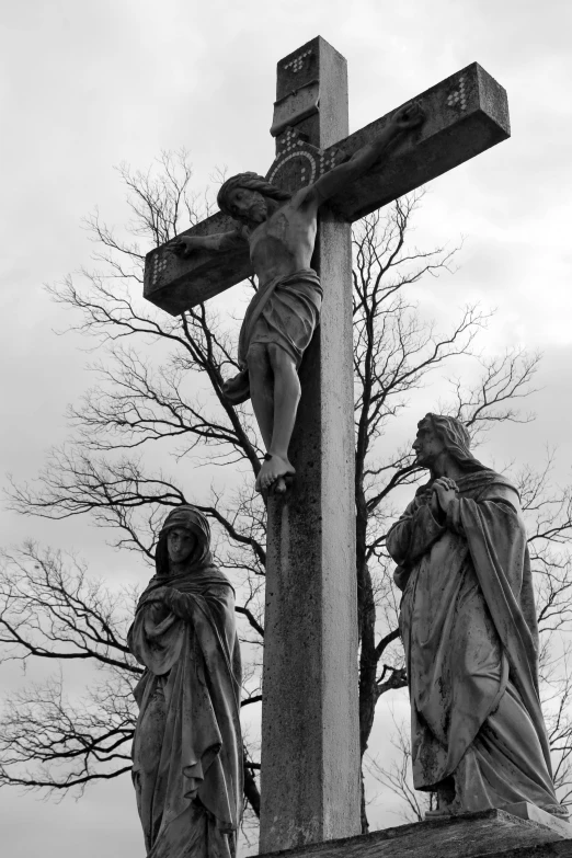 a cross with three crucifixs in front of it