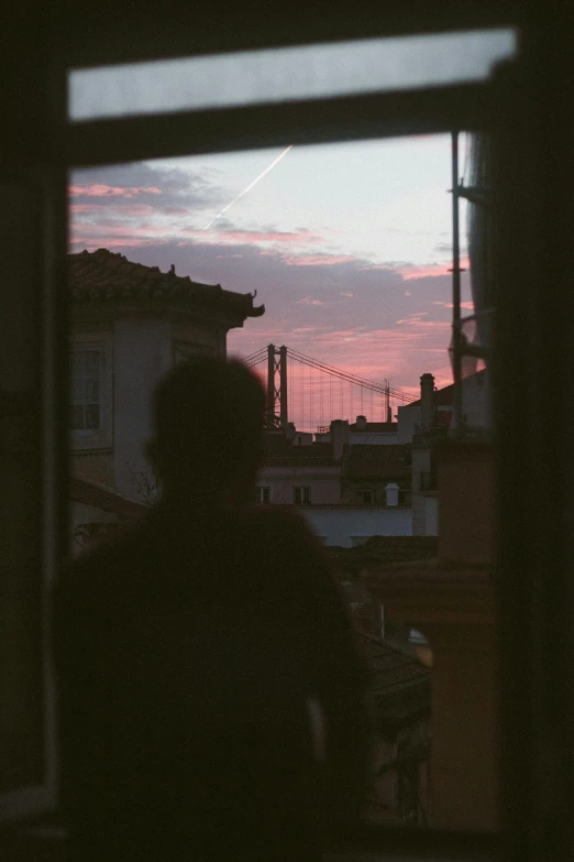 people look out the window during sunset at their homes