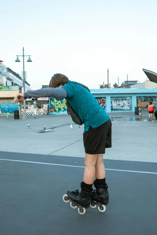 a man riding a skateboard in a parking lot