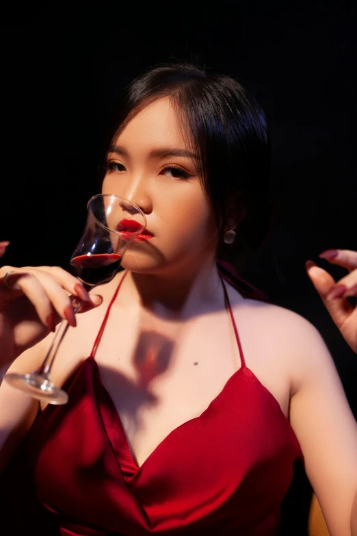 woman in red halter with a glass of wine