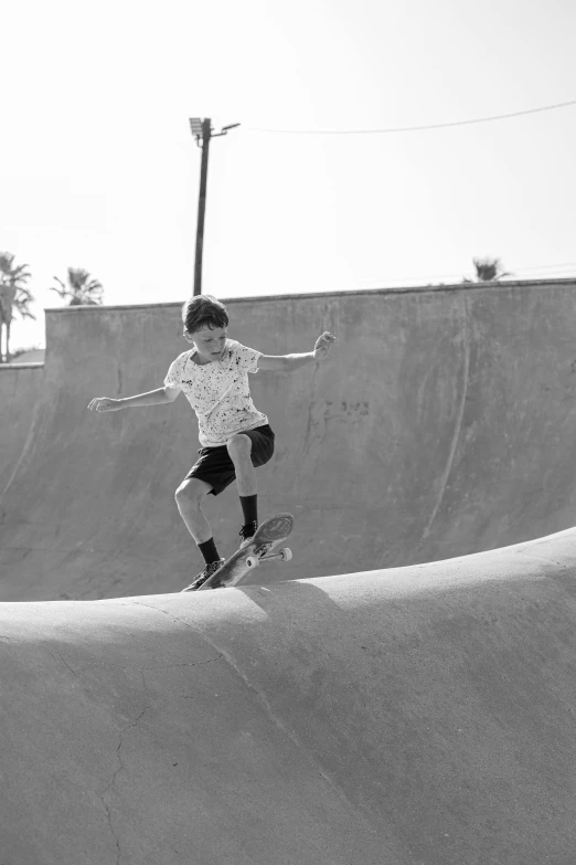 a  is riding a skateboard on a ramp