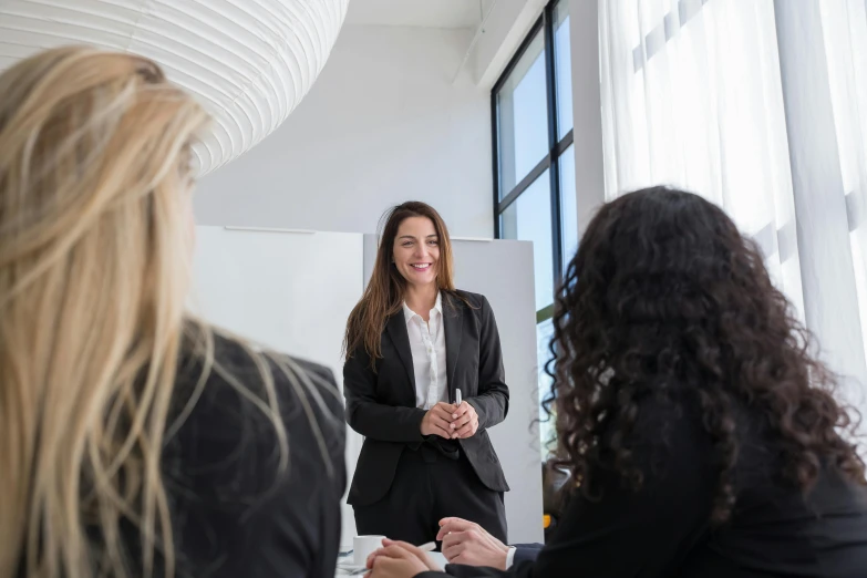 woman talking to two other people in office