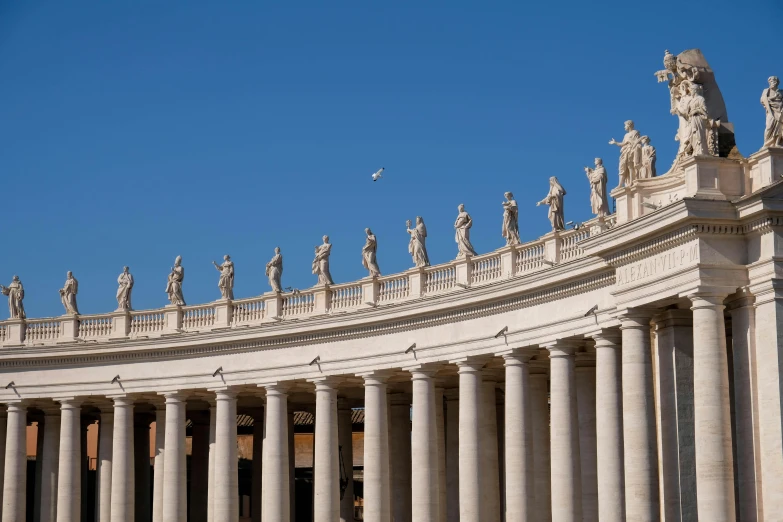 the facade of a building with rows of stone pillars