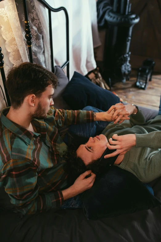 a woman smiling at another man who is petting her arm