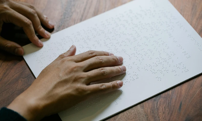 a person's hand resting on top of a paper