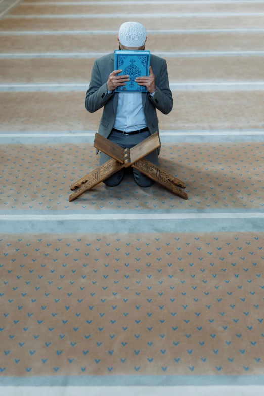 a person wearing a white turban is sitting on the floor